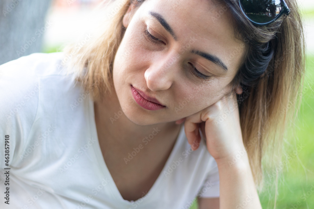 Fototapeta premium Young woman feeling sad while wandering outside. Stress and depression concept.