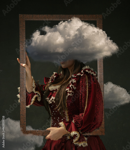 Female model like medieval royalty person in vintage clothing. Concept of comparison of eras, artwork. Creative collage. Surrealism photo