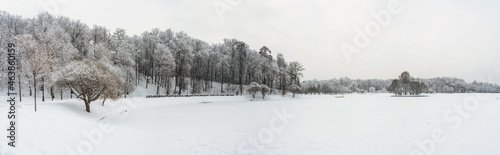Winter view of a snow-covered pond and trees around © Evgeniya Fedorova
