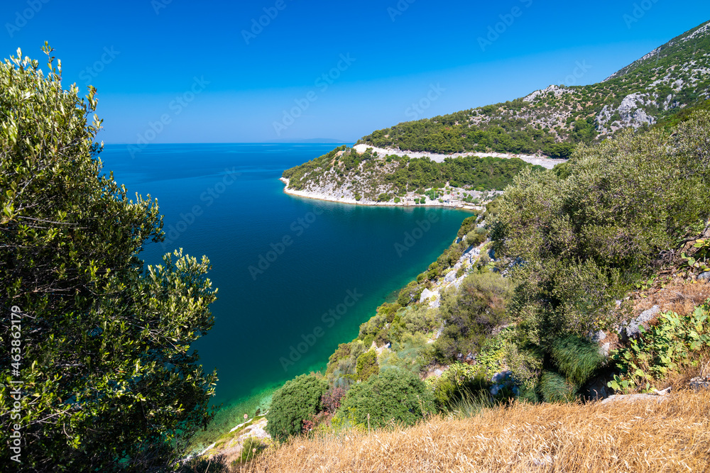 View of beautiful Croatia coast near Makarska. Blue sea with white beach. Isles in the background. Summer weather, blue sky.