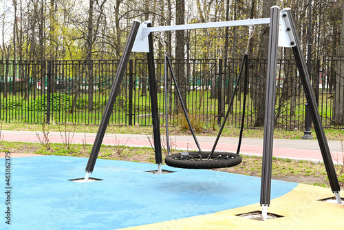 Modern children's swing in the park.