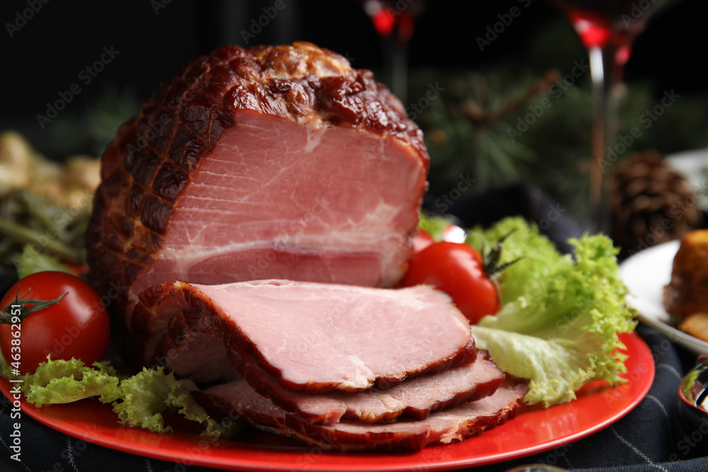 Plate with delicious ham, lettuce and tomatoes on black wooden table, closeup Plate with delicious ham, lettuce and tomatoes on black wooden table, closeup