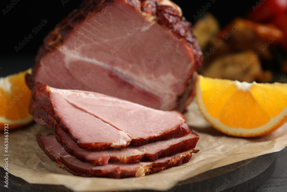 Cut delicious ham and orange on parchment paper, closeup Cut delicious ham and orange on parchment paper, closeup