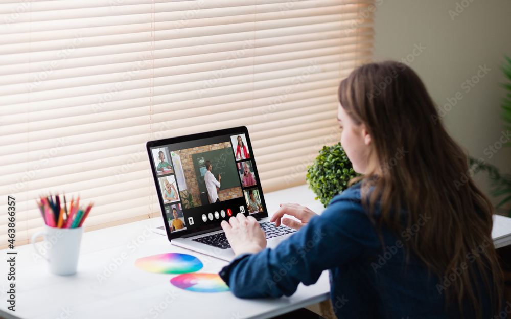 Caucasian girl using laptop for video call, with smiling diverse high school pupils on screen Caucasian girl using laptop for video call, with smiling diverse high school pupils on screen