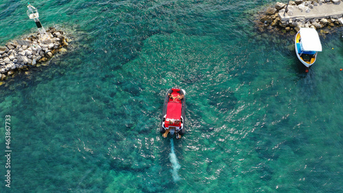 Aerial dronephoto of inflatable rigid power boat cruising in high speed in Mediterranean emerald bay