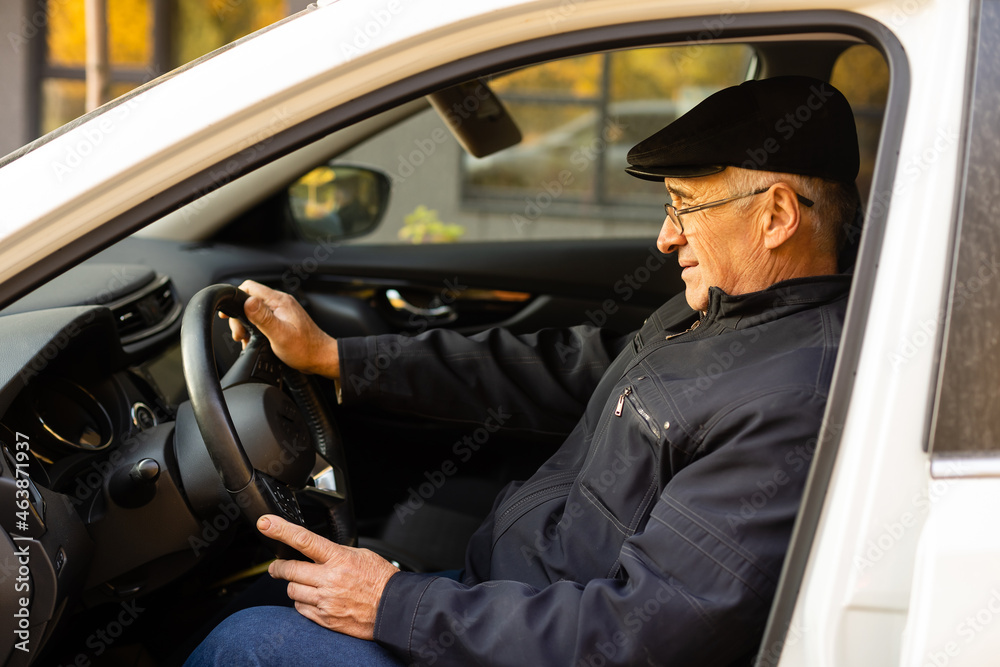 Smiling happy elderly man in the new car Smiling happy elderly man in the new car