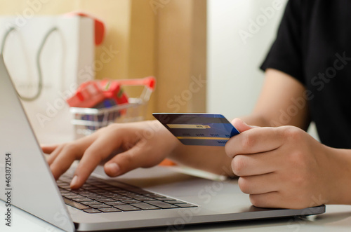 young businesswoman holding credit card and typing on laptop for online shopping Ready to pay online, make purchases on the Internet. online payment business finance and technology