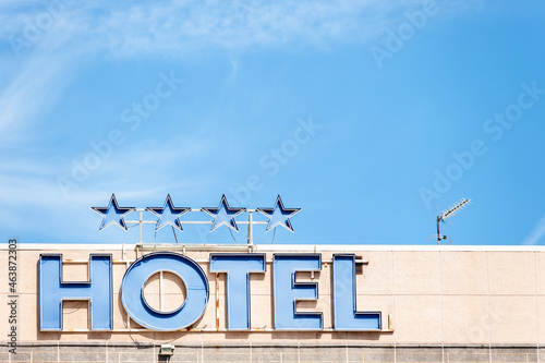 Top view of a hotel with a sign with the neon lights off that says 