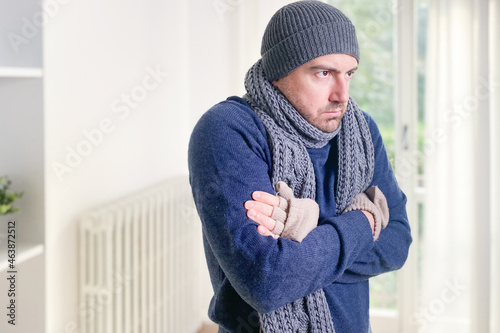 Canvas Print Man suffering cold at home and problem with house heating