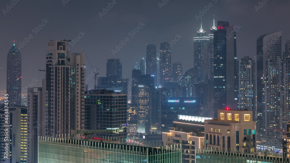 Fototapeta premium Dubai skyscrapers with illumination in business bay district night timelapse.