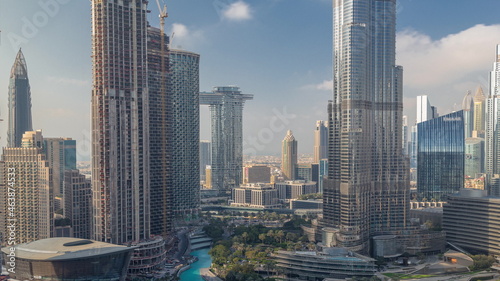 Skyscrapers rising above Dubai downtown timelapse, mall and fountain surrounded by modern buildings aerial top view