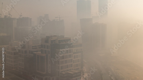 Modern city architecture in Business bay district during sunrise. Panoramic view of Dubai s skyscrapers foggy morning timelapse