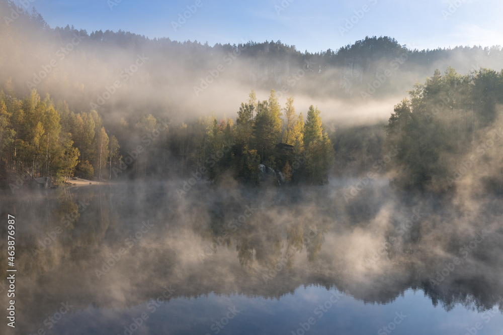 Beautiful colored trees with lake in autumn, landscape photography. Late autumn and early winter period. Outdoor and nature.
Amazing foggy morning. Lake coast. Fog over autumn lake water.