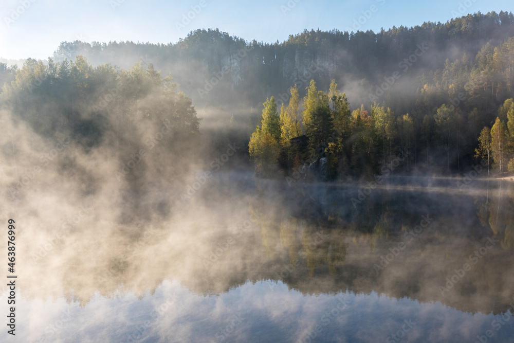 Beautiful colored trees with lake in autumn, landscape photography. Late autumn and early winter period. Outdoor and nature.
Amazing foggy morning. Lake coast. Fog over autumn lake water.