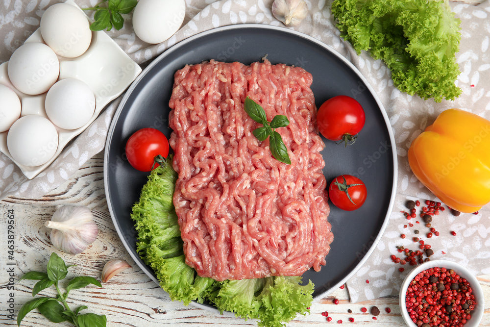 Raw chicken minced meat and ingredients on white wooden table, flat lay