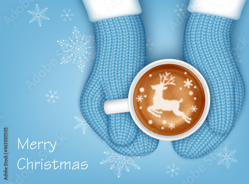 Hands in knitted mittens holding a cup of coffee. Christmas greeting card template