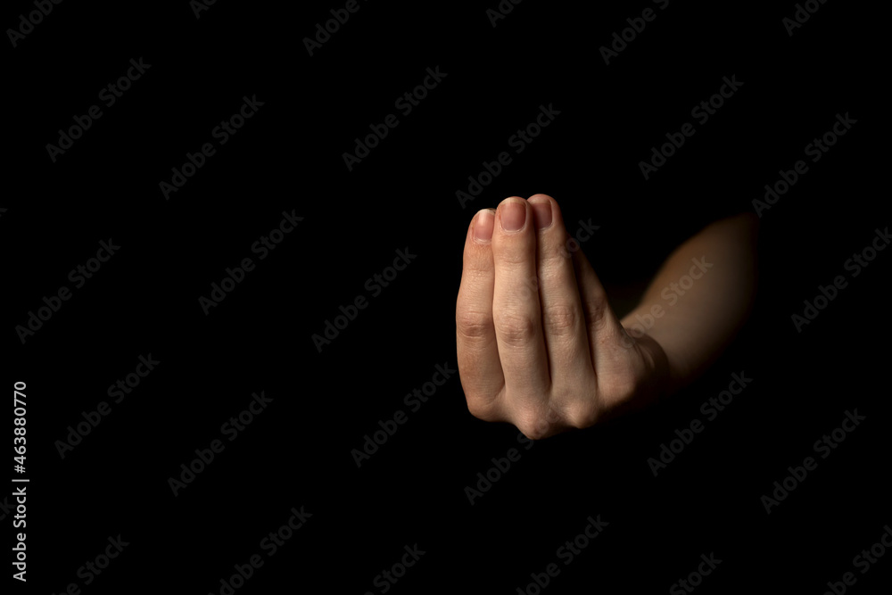 Female hand gesture on a black background with copy space photo Female hand gesture on a black background with copy space photo