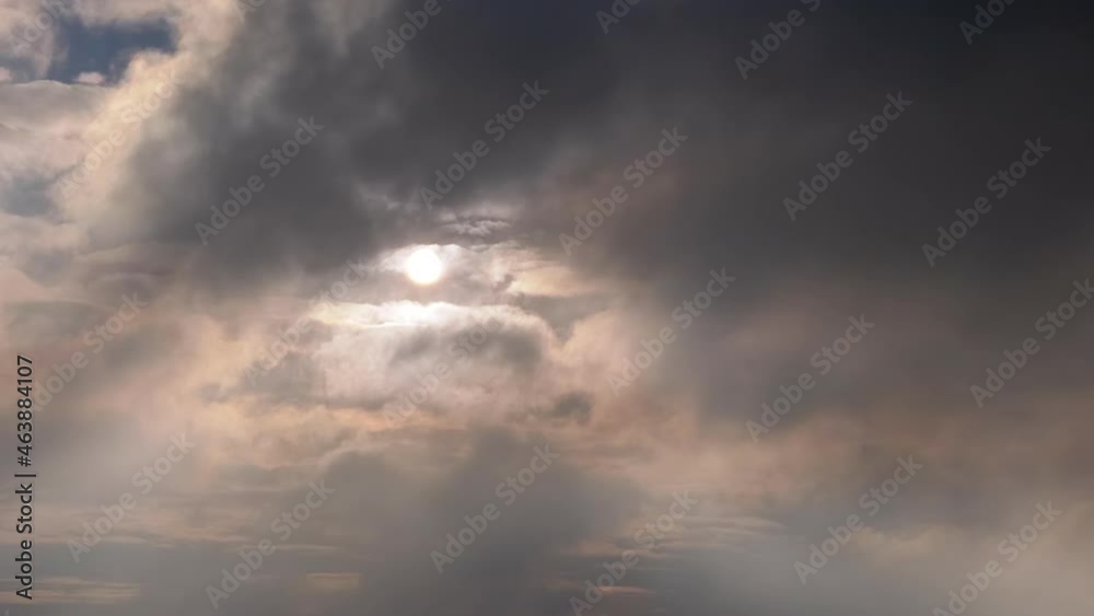 Gloomy Rainy Gray Cumulus Clouds Moving over the Rising Sun. Dawn. Sunrise. Sunbeams break through a heavy dark, black clouds blocking sunlight. Wind, fog, haze. Gloomy, mystical atmosphere. Morning. Gloomy Rainy Gray Cumulus Clouds Moving over the Rising Sun. Dawn. Sunrise. Sunbeams break through a heavy dark, black clouds blocking sunlight. Wind, fog, haze. Gloomy, mystical atmosphere. Morning.