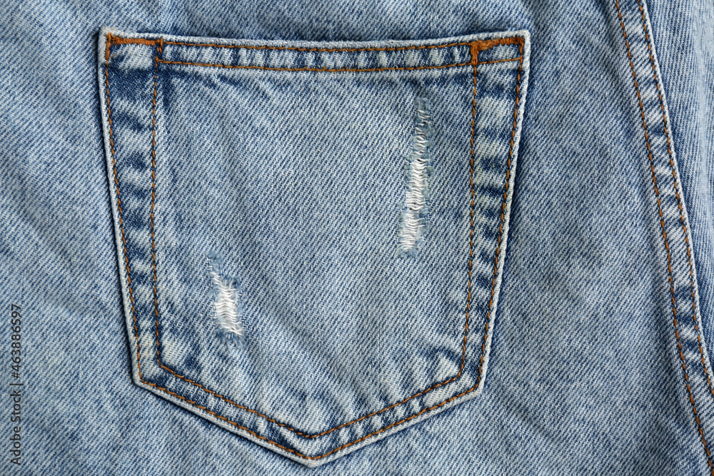Light blue jeans with back pocket as background, closeup Light blue jeans with back pocket as background, closeup