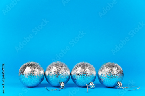 New Year s and Christmas. shiny  silver Christmas balls on a blue  light blue background. Flat lay. Merry Christmas and Happy Holidays greeting card  frame  banner. New Year. Winter holiday theme.