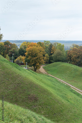 Green hills and yellowed autumn trees