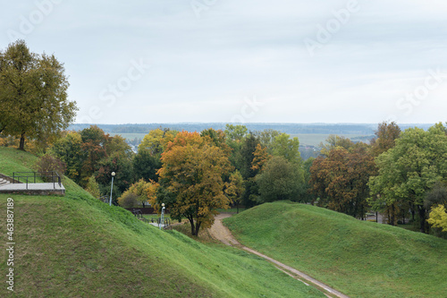 Green hills and yellowed autumn trees