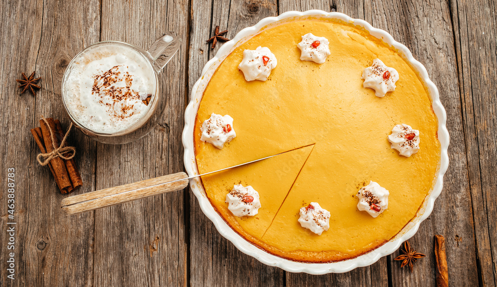 Homemade pumpkin cheesecake with coffee on wooden background, banner, menu, recipe place for text, top view
