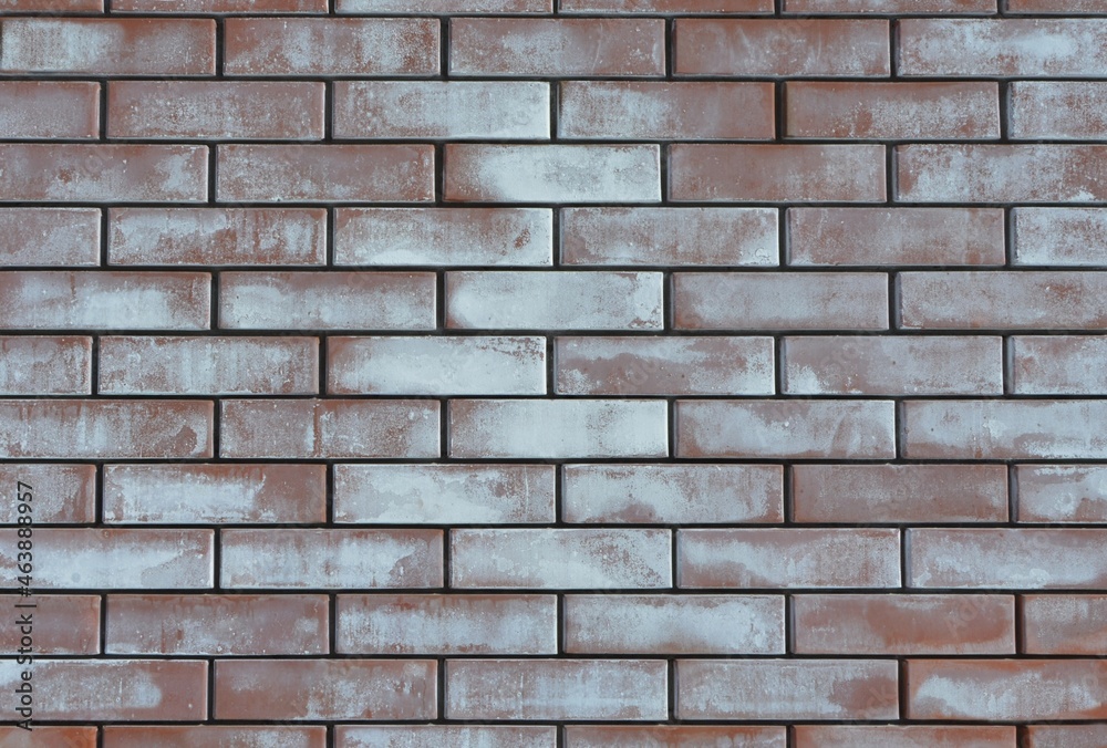Textured red whitened weathered tarnished old brick wall background Textured red whitened weathered tarnished old brick wall background