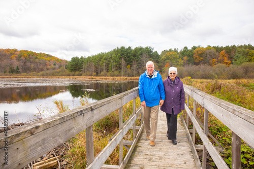 A Senior couple spends a fall day outdoors walking, relaxing and working in the garden.