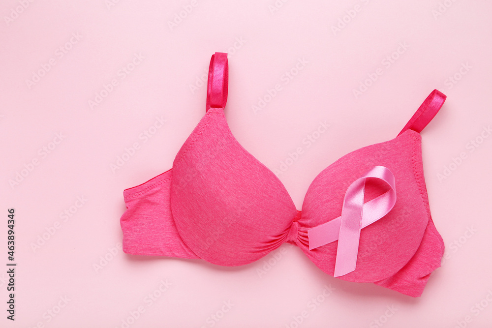 Ribbon with female bra on pink background Ribbon with female bra on pink background