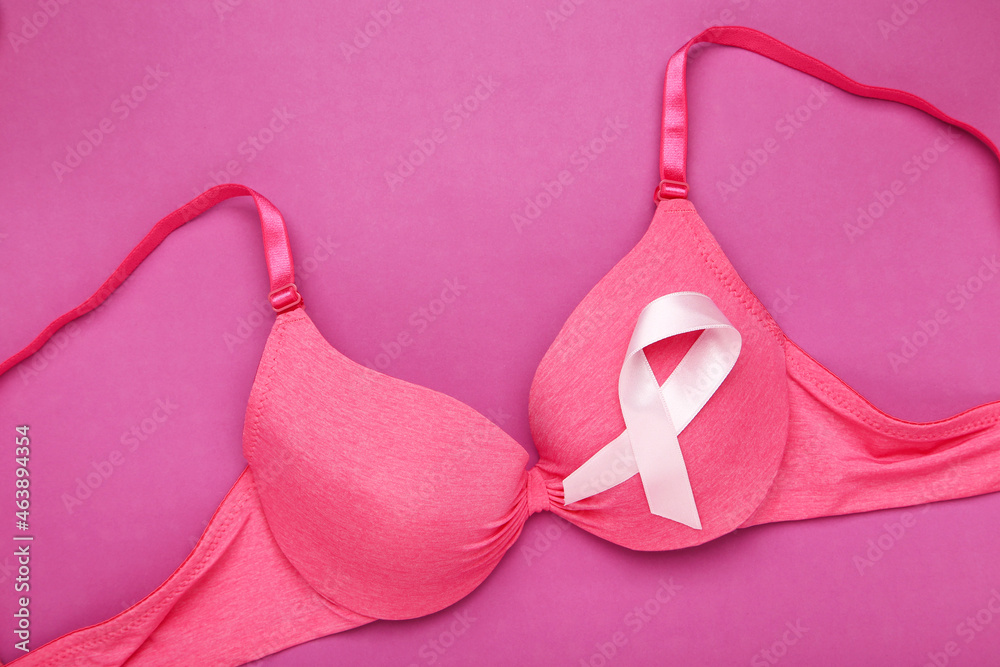 Ribbon with female bra on pink background Ribbon with female bra on pink background