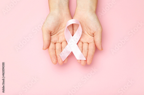 Breast cancer concept. Female hands holding pink ribbon