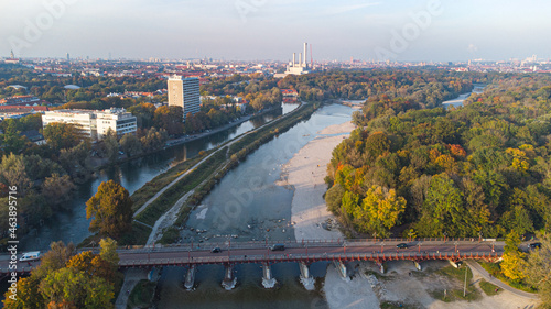 Aerial views of autumn in Munich. Isar river seen from above with colorful trees nearby