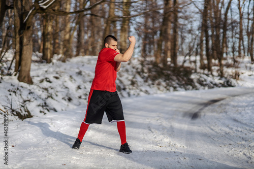 Strong muscular fighter sparring in nature at snowy winter day. Boxing, winter fitness © dusanpetkovic1