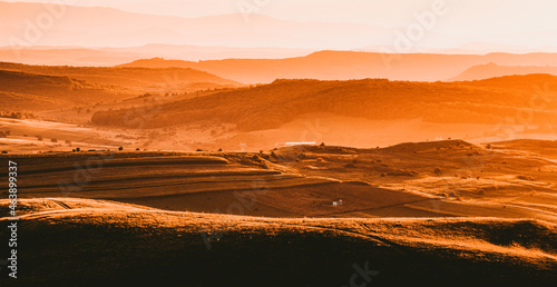 autumn landscape with hills in sunset light
