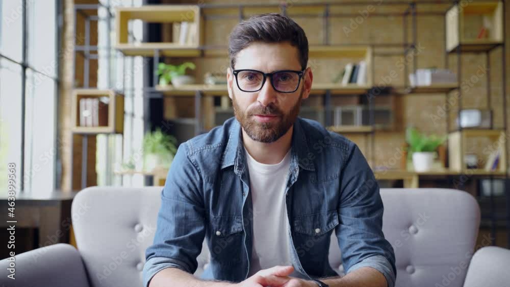 Smart caucasian business man talking to camera making online conference call