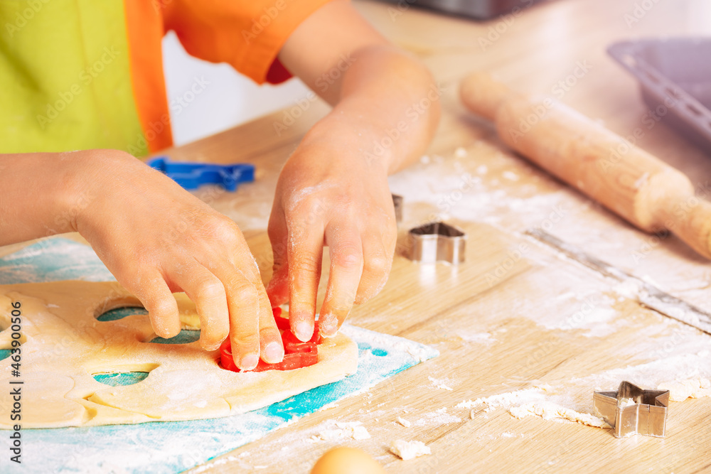 Close-up of boys hands cutting out cookies shapes Close-up of boys hands cutting out cookies shapes