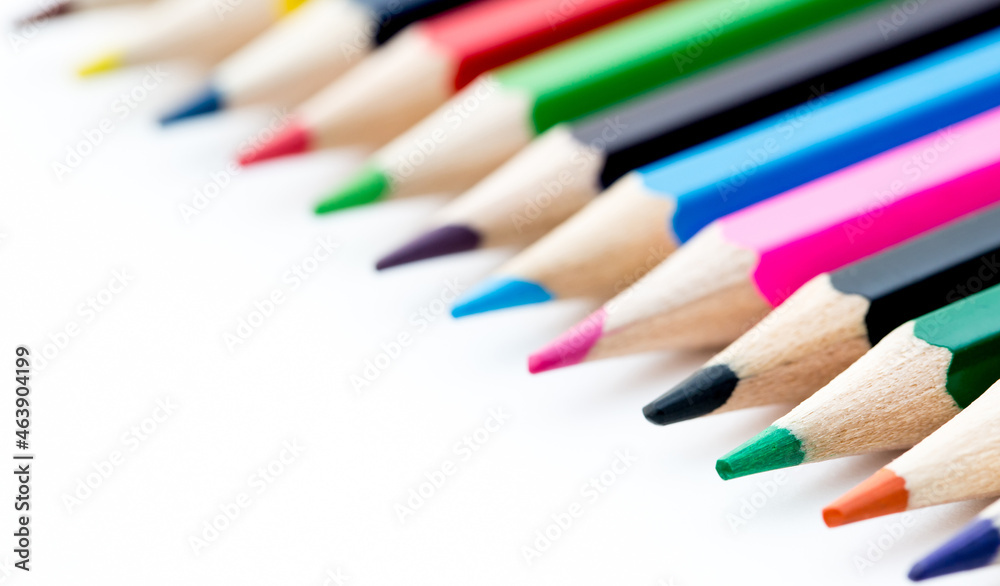 School stationery items. Creation Multicolored pencils on a blank white sheet. On a white background. Children's drawing, artist. School stationery items. Creation Multicolored pencils on a blank white sheet. On a white background. Children's drawing, artist.