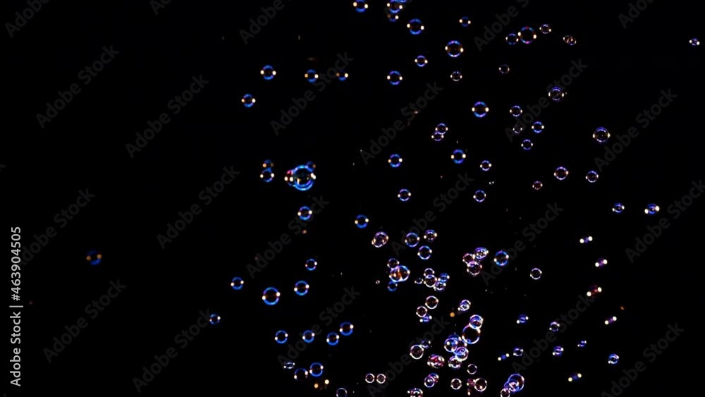The flying soap bubbles on the dark background. slow motion The flying soap bubbles on the dark background. slow motion