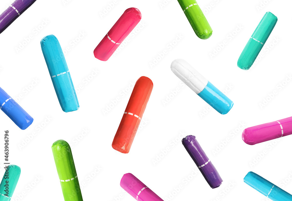 Many tampons in colorful packages falling on white background