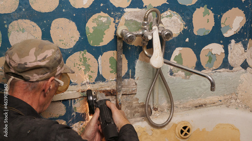 A worker is dismantling the bathroom