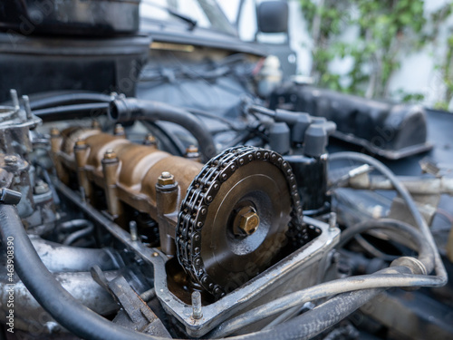 Mechanic repairing old engine with lighting