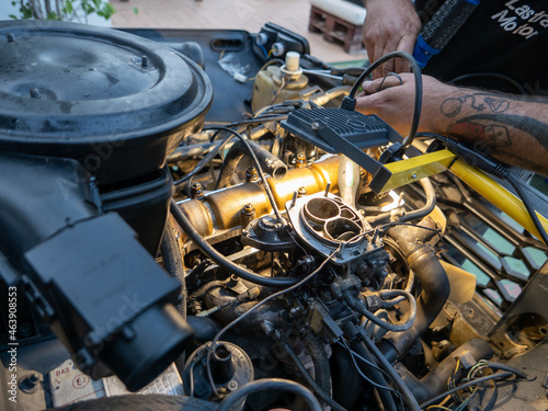Mechanic repairing old engine with lighting