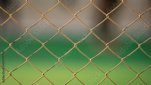 Close up of old chain fence at a football ground.