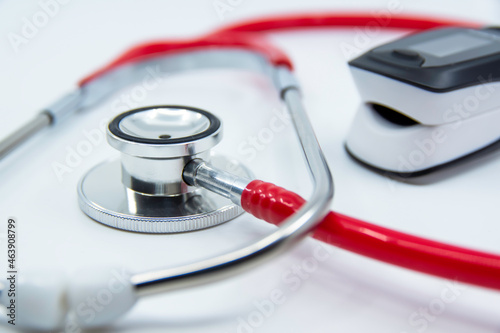 Stethoscope and Pulse Oximeter isolated on white background. Pulse Rate Health Tester is used to measure air in lungs. Covid-19, healthcare concept.	