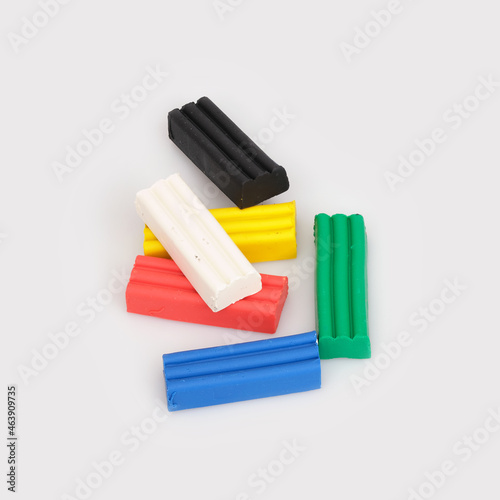 Stack of pieces of multicolored plasticine isolated on white background
