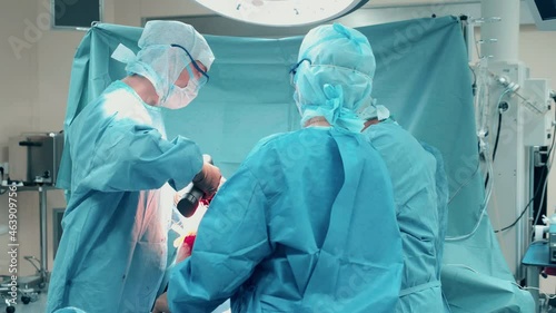 Operation performed by a team of surgeons behind a curtain photo