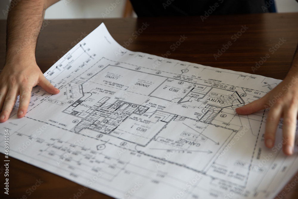 close up of a person looking at plans close up of a person looking at plans