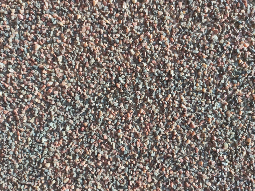 the texture of the wall is made of fine multicolored stone chips the texture of the wall is made of fine multicolored stone chips