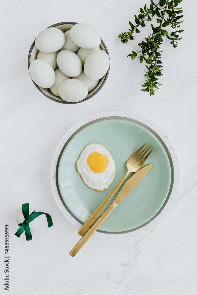 Easter flat lay with green eggs on a white marble Easter flat lay with green eggs on a white marble